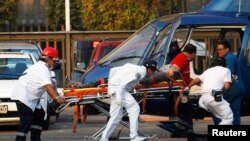 Paramedics wheel an injured person to a helicopter at the parking lot of the state-run oil company Pemex after an explosion in Mexico City, January 31, 2013.