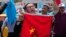 FILE - Uighurs living in Turkey and Turkish supporters, chant slogans as they hold a Chinese flag before burning it during a protest near China's consulate in Istanbul, against what they call oppression by Chinese government to Muslim Uighurs in far-western Xinjiang region, July 5, 2015. 