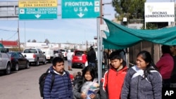 The Gonzalez family of five from Guatemala, who are applying for asylum in the U.S., stand for a family portrait before going to a soup kitchen to eat in Nogales, Mexico, on the U.S. border, Jan. 3, 2020.