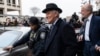 Roger Stone, center, departs federal court in Washington, Feb. 20, 2020.