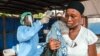 FILE - A woman has her temperature taken as part of Ebola prevention, prior to entering the Macauley government hospital in Freetown, Sierra Leone, Jan. 21, 2016. 