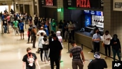 People wait in line to vote early at the State Farm Arena on Oct. 12, 2020, in Atlanta. 