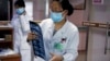 In this Thursday, Dec. 8, 2016 photo, a nurse looks at a CT scan of a lung cancer patient before passes to a doctor at the Jingdong Zhongmei private hospital in Yanjiao, China's Hebei Province. 