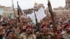 Shiite rebels, known as Houthis, hold up their weapons to protest Saudi-led airstrikes during a rally in Sanaa, Yemen, March 26, 2015. 