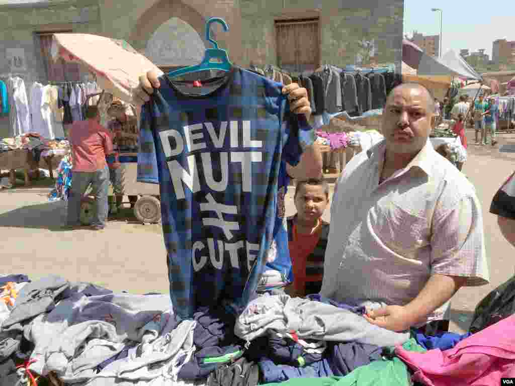 Khaled El-Antably and with his sons Ahmed and Mahmoud are buying new shirts for the hot summer. Khaled says “Prices here is very low compared to the big malls. The quality is not the best, but what can we do? Nothing lasts.” 27 May 2016, Cairo. (Photo
