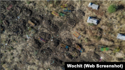 This file aerial view taken on November 21, 2020 shows a cemetery where alleged victims of the November 9, 2020 massacre were buried in collective graves, in Mai Kadra, Ethiopia.