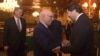 Afghanistan’s deputy foreign minister, Hekmat Khalil Karzai, right, and Pakistani foreign affairs adviser Sartaj Aziz exchange greetings before a four-nation meeting in Islamabad, Jan. 11, 2016. Richard Olson, a U.S. special representative, appears at left.