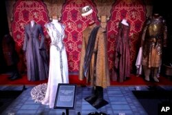 FILE - In this April 10, 2019, file photo costumes of the characters Joffrey Baratheon and Margaery Tyrell on display during the launch of The Game of Thrones Touring Exhibition at the Titanic Exhibition centre in Belfast, Northern Ireland.