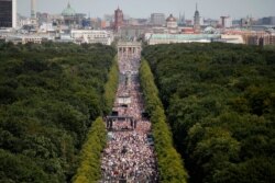 People gather at the Brandenburg gate for a demonstration with the slogan‚ The end of the pandemic - freedom day, against coronavirus restrictions in Berlin, Germany, Aug. 1, 2020.
