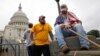 U.S. Army veterans end a day of protest with a group from the "Million Vet March on the Memorials," rallying against the closure of the U.S. National World War Two Memorial due to the current U.S. government shutdown in Washington, October 13, 2013.