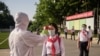 A student has her temperature taken as part of anti Covid-19 procedures before entering the Pyongyang Secondary School No. 1 in Pyongyang, North Korea, June 22, 2021. 