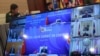 A TV screen shows Vietnamese Prime Minister Nguyen Xuan Phuc, center, addressing the Special ASEAN summit online to discuss actions coping with the COVID-19 pandemic, Hanoi, Vietnam Tuesday, April 14, 2020. (AP Photo/Hau Dinh)