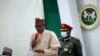 FILE - Nigeria's President Muhammadu Buhari speaks during a meeting in Katsina, Nigeria, Dec. 18, 2020. 