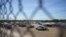 FILE - United States Border Patrol vehicles and temporary structures are pictured under the Del Rio Port of Entry during its reopening after being closed for over a week due to an influx of migrants, Sept. 25, 2021.