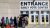 A line of early voters waits outside the Franklin County Board of Elections, Monday, Nov. 7, 2016, in Columbus, Ohio. Heavy turnout has caused long lines as voters take advantage of their opportunity to vote before election day.