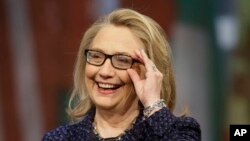 Secretary of State Hillary Rodham Clinton adjusts her glasses during a Global Townterview at the Newseum in Washington, January 29, 2013.