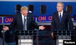 Republican U.S. presidential candidates businessman Donald Trump and former Florida Governor Jeb Bush talk simultaneously during the second official Republican presidential candidates debate.
