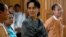 National League for Democracy (NLD) party leader Aung San Suu Kyi smiles as she arrives to attend Union Parliament in Naypyitaw January 28, 2016. REUTERS/Soe Zeya Tun - RTX24BTR