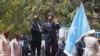 Somalia's newly elected President Mohamed Abdullahi Mohamed (right) flanked by outgoing president Hassan Sheikh Mohamud (left) attends a military parade during the hand-over ceremony at the Presidential palace in Somalia's capital Mogadishu, Feb. 16, 2017