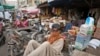 FILE - Laborers wait for work at a market, in Karachi, Pakistan, July 13, 2023. The International Monetary Fund said on March 20, 2024, it reached an agreement with Pakistan's government for the last payment under a $3 billion bailout package.