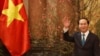 FILE - Vietnam's President Tran Dai Quang waves his hand to the media as he waits for arrival of Japan's Prime Minister Shinzo Abe at the Presidential Palace in Hanoi, Vietnam, Jan. 16, 2017. 
