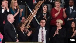 도널드 트럼프 미국 대통령이 30일 국정연설에서 탈북자 지성호 씨를 소개하자 지 씨가 목발을 들어보이고 있다.