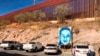 FILE - This is the boundary between the U.S. and Mexico at Nogales, Mexico, Dec. 4, 2017. The poster is of Juan Antonio Elena Rodriguez, a teen who was shot and killed by a Border Patrol agent who shot through the fence in 2010. 