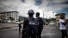 FILE - Cameroonian policemen patrol the market in the majority English-speaking province in Buea, Cameroon.