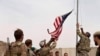 A U.S. flag is lowered as American and Afghan soldiers attend a handover ceremony from the U.S. Army to the Afghan National Army, at Camp Anthonic, in Helmand province, southern Afghanistan, May 2, 2021. (Afghan Ministry of Defense Press Office)
