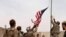 A U.S. flag is lowered as American and Afghan soldiers attend a handover ceremony from the U.S. Army to the Afghan National Army, at Camp Anthonic, in Helmand province, southern Afghanistan, May 2, 2021. (Afghan Ministry of Defense Press Office)