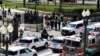 U.S. Capitol Police officers investigate near a car that crashed into a barricade on Capitol Hill near the Senate side of the U.S. Capitol in Washington, April 2, 2021. 