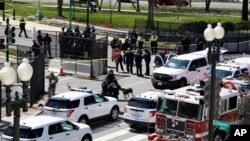 U.S. Capitol Police officers investigate near a car that crashed into a barricade on Capitol Hill near the Senate side of the U.S. Capitol in Washington, April 2, 2021. 