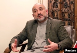 FILE - Mohammad Haneef Atmar, former national security adviser and candidate in the upcoming presidential election, speaks during an interview in Kabul, Afghanistan Feb. 23, 2019.
