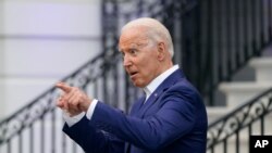 President Joe Biden speaks with an attendee during an Independence Day celebration on the South Lawn of the White House, Sunday, July 4, 2021, in Washington. (AP Photo/Patrick Semansky)