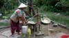 A villager in Samrong commune pumps water out of a well, Svay Rieng province, Cambodia, July 18, 2017. (Sun Narin/VOA Khmer)