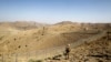 FILE - A soldier stands guard along a border fence on the border with Afghanistan in North Waziristan, Pakistan, Oct. 18, 2017. Militant attacks against Pakistani security outposts Friday reportedly resulted in the deaths of at least six soldiers and injuries to 14 others. 