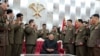 North Korean leader Kim Jong Un, sitting center, is surrounded by senior military officials holding “Paektusan” commemorative pistols they received from him during a ceremony in Pyongyang, July 26, 2020. (Photo released by the North Korean Government)