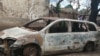 FILE - A burnt motor viehicle is seen following post-election violence in Lilongwe, Oct. 8, 2019. (Lameck Masina/VOA)
