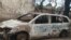 FILE - A burnt motor viehicle is seen following post-election violence in Lilongwe, Oct. 8, 2019. (Lameck Masina/VOA)
