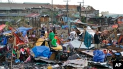 Residents salvage what's left of their homes damaged by Typhoon Rai in Cebu city, central Philippines on Dec. 17, 2021.