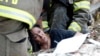 A woman is pulled out from under tornado debris at the Plaza Towers School in Moore, Oklahoma, May 20, 2013. 
