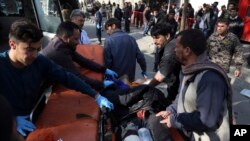 Un blessé est porté sur une civière à l'extérieur d'un hôpital après un attentat-suicide à Kaboul, Afghanistan, 27 janvier 2018.