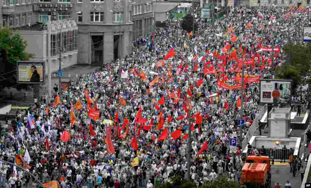Demonstrators hold the flags of various groups during a massive protest against Putin&#39;s rule in Moscow, Tuesday, June 12, 2012. 