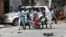 Civilians carry the dead body of a man killed in a car bomb explosion near a hotel in Mogadishu, Somalia, March 28, 2019. 