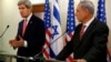 Israeli Prime Minister Benjamin Netanyahu (R) listens as U.S. Secretary of State John Kerry speaks during a news conference following a meeting at Netanyahu's office in Jerusalem, Dec. 5, 2013. 