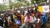 Catholic devotees wait for Pope Francis to arrive to lead a mass in Kampala, Uganda, November 28, 2015.