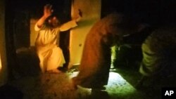 This image made from video taken on Thursday, Oct. 22, 2015 from a helmet camera, shows U.S. and Iraqi special forces freeing hostages from a prison controlled by Islamic State militants.
