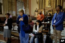 People pray for the crew of the missing Argentine submarine ARA San Juan during a mass at the Buenos Aires's Cathedral, in Argentina, Nov. 21, 2017.