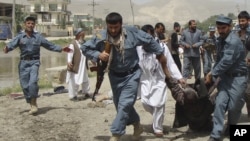 Polisi Afghanistan menggevakuasi seorang korban ledakan bom bunuh diri di Pul-i-Khumri, provinsi Baghlan, utara Afghanistan (20/5). Rangkaian serangan bom terus mengguncang negara ini. Dilaporkan enam polisi tewas setelah kendaraan yang mereka tumpangi melindas bom di pinggir jalan distrik Obe, provinsi Herat, Selasa (21/5).