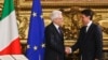 Italian President Sergio Mattarella (L) shakes hands with Premier Giuseppe Conte during the swearing-in ceremony for Italy's new government at Rome's Quirinale Presidential Palace, June 1, 2018. 
